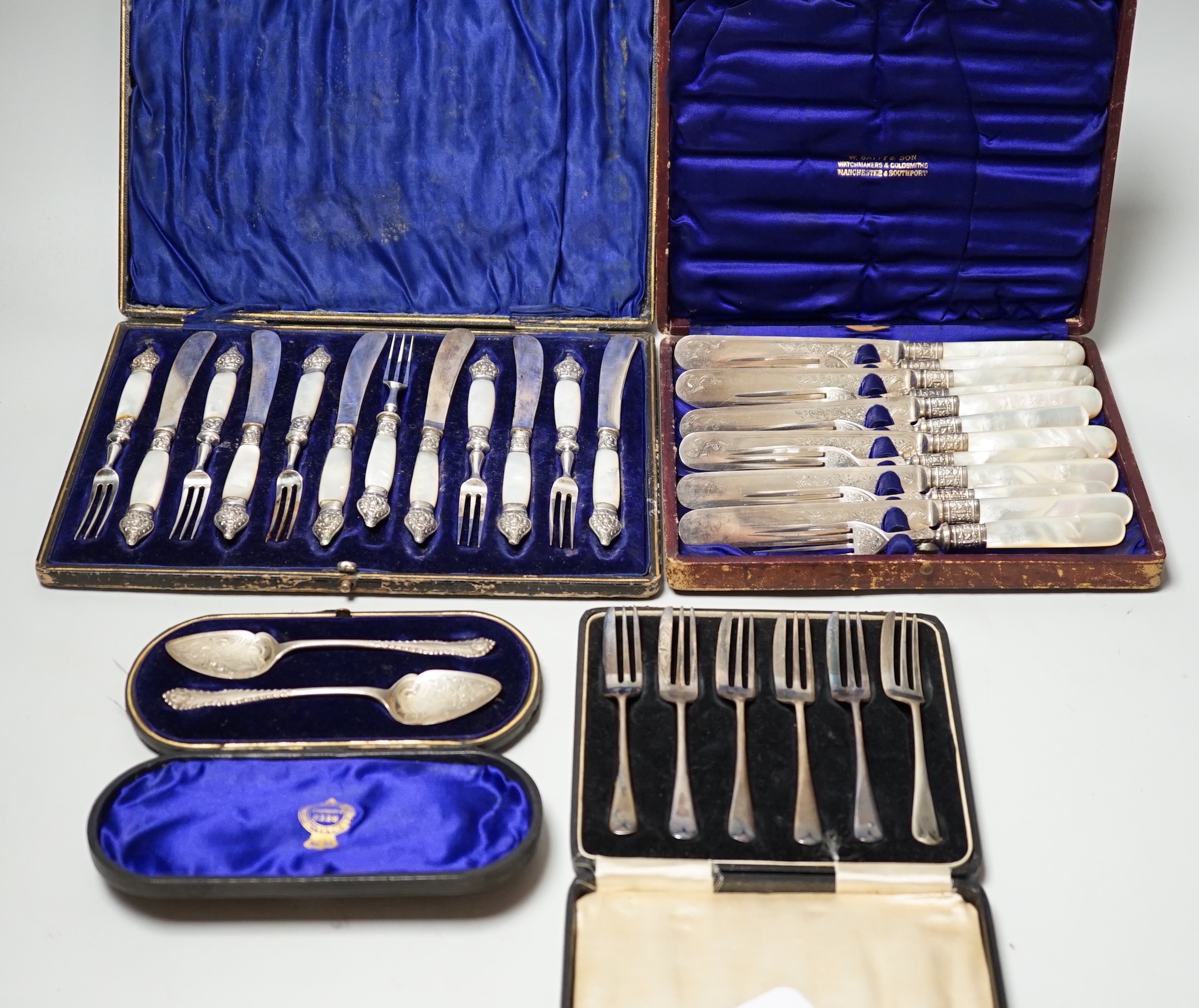 Two cased sets of silver flatware including teaspoons and pair of small servers and two cased sets of plated flatware.